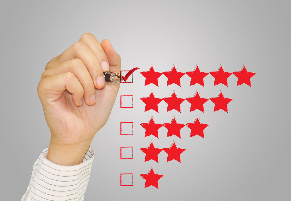 Hand,Check,Mark,With,Red,Marker,On,Five,Star,Rating.